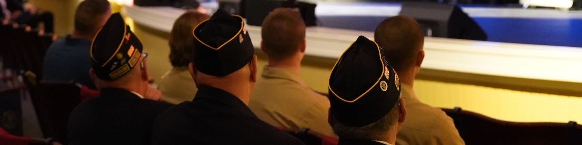 Veterans sit in Clayton Center auditorium and listen to speaker
